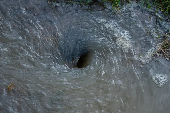 A picture of a flood forming a whirlpool