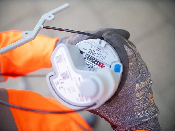Close up of employee holding a smart meter with antenna